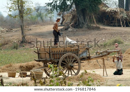 MANDALAY,MYANMAR-MARCH 19 : Unidentified farmer loading up on their buffalo cart, carrying supplies  to a village on March 19,2014 in Mandalay city,Middle of Myanmar.