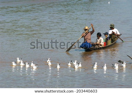 INLE,MYANMAR-FEBRUARY1: Local people transportation on boat going through a water canal in the floating on the western side of the lake on February 1,2014 in Inle Lake,Shan state in Middle of Myanmar.