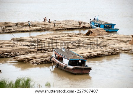 AMARAPURA,MYANMAR-JULY 1 : Bamboo raft on Port activities in Ayeyarwaddy river for sell on July 1,2014 in Amarapura city in Central of Myanmar.