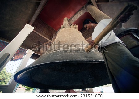 Man hitting is religion the Mingun Bell is one of the world\'s largest ringing bells. The weight of the bell is 90 tons or199,999 pounds and about 13 feet tall in Sagaing Division , Central of Myanmar
