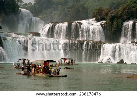 NANNING,CHINA - OCT 11:Traveler enjoy the beauty of nature by rafting at Datian waterfall,it is currently the 4th largest waterfall along a National border on October 11,2014 in Daxin ,Nanning,China.