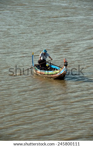 AMARAPURA,MYANMAR-JUN 30: Unidentified local citizens paddle wooden boat on Taungthaman lake near U-Bein Bridge is believed to be the oldest teak bridge in the World on June 30,2014,Amarapura,Myanmar.