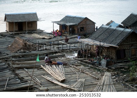 MANDALAY,MYANMAR-JULY 2 : Daily life at bamboo raft on Port activities in Ayeyarwaddy river for sell on July 2,2014 in Mandalay city in Central of Myanmar