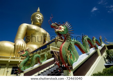 Green dragon Front of golden big Buddha in Thai temple at Middle of Thailand.