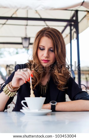 Beautiful girl drinking coffee outside