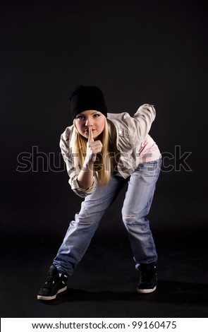 Modern dance, hip hop girl dancer on a black background.