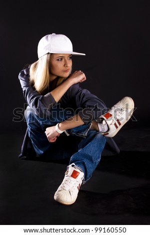 Modern dance, hip hop girl dancer on a black background.