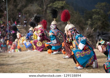 THIMPHU, BHUTAN - DECEMBER 13: Dancers with tradition mask dance at yearly festival called Tshechu Festival on December 13, 2012 in Bhutan