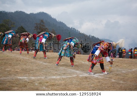 THIMPHU, BHUTAN - DECEMBER 13: Dancers with tradition mask dance at yearly festival called Tshechu Festival on December 13, 2012 in Bhutan