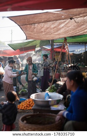 NYAUNG SHWE, MYANMAR - FEBRUARY 15: Mingalar Market, is a big market selling rice, fish, vegetables, flower, clothes, souvenirs on Feb 15, 2014 in Nyaung Shwe, Myanmar.
