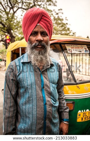 AGRA, INDIA - APRIL 12: Unidentified man who dress indian tradition cloth hat and drive  public car transportation that's call 'auto rickshaw' on Apr 12, 2014 in Agra, India.