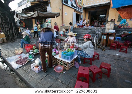 HOI AN, VIETNAM - OCTOBER 21: Unidentified Vendors selling food, vegetable and souvenir at the old local market in Hoi An, Vietnam on Oct 21, 2014.
