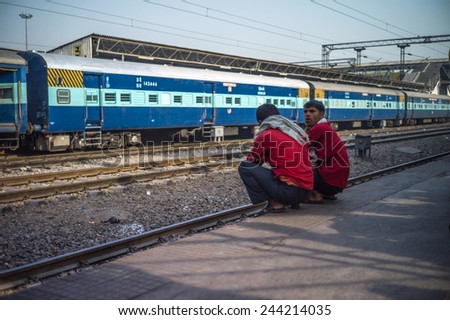 NEW DELHI, INDIA - APRIL 12: Unidentified indian peoples waiting for the train at old railway station, largest railway station. It handles over 350 trains and 500,000 passengers daily on Apr 12, 2014.