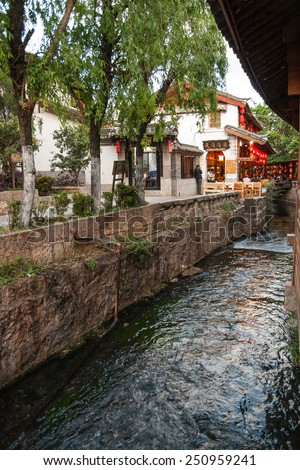 LIJIANG, CHINA - APRIL 12: Unidentified peoples visit Old town of Lijiang, It\'s a mainly non-Han town with a traditional Nakhi culture of the majority ethnic group on April 12, 2009 in Lijiang, China.