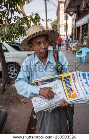 YANGON, MYANMAR - FEBRUARY 28 : Unidentified Newspaper Seller on the side street in Yangon, Myanmar on February 28, 2015.