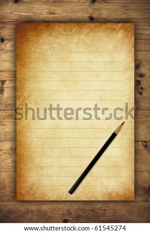 vintage letter paper with black pencil on wooden background