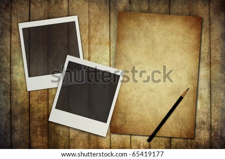 vintage paper with photo frame on vintage wooden background