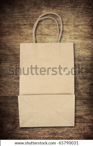 paper bag backside on old wooden background for natural recycle concept