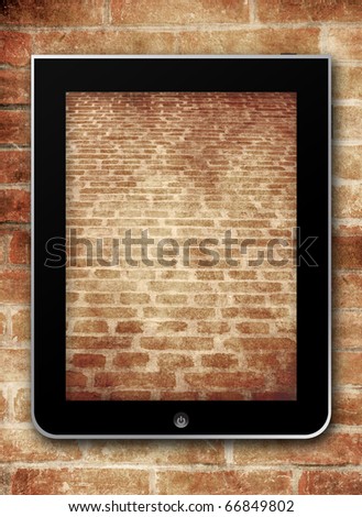 Tablet touchscreen with brick wallpaper on brick stone background