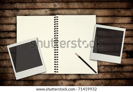 Blank book on bamboo wooden background with Photo frame