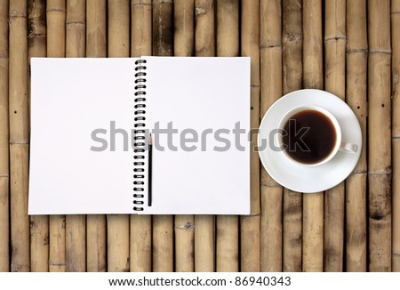 blank notebook coffee cup on bamboo background