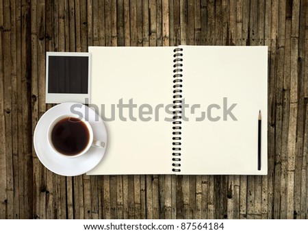 Book with coffee on bamboo plate