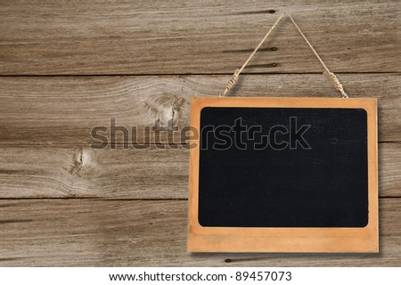 blank chalkboard with space hanging on wooden background