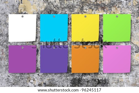 blank color note paper attach on high grunge wall