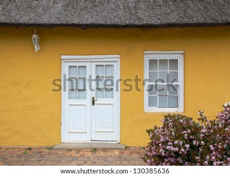 The front entrance to a traditional thatched cottage in the town of Greyton, in the Overberg region of the Western Cape, South Africa.