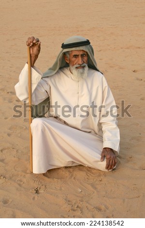 DUBAI - MARCH 8, 2005: An elderly, blind Arab man in the desert near Dubai.