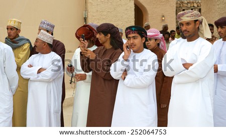 MUSCAT, OMAN - FEBRUARY 1, 2008: Omani men watching a tribal dance in Muscat, in the Sultanate of Oman.