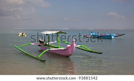 Traditional jukungs (outrigger canoes) moored off Bali\'s Tuban Beach, Indonesia.