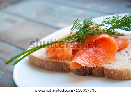 Smoked salmon served in freshly baked sourdough bread garnished with fresh dill.
