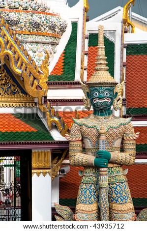 Thai statue and architectural detail at the Temple of the Emerald Buddha, Bangkok, Thailand.