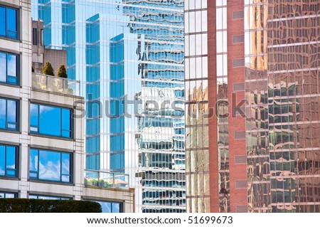Modern city architecture on a bright sunny day. The small roof garden and terrace contrasts with the urban architecture and busy city lifestyle.