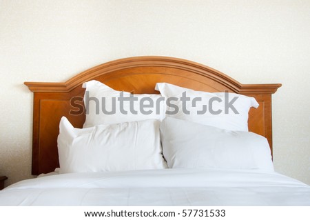 Pillows piled at the head of a large queen size double bed.