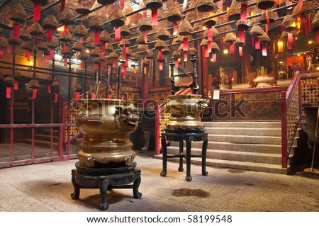 The interior of the Man Mo Temple, Hong Kong, with incense offerings and coils suspended from the ceiling.