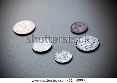 US currency. A Dime, Quarters, Nickel and a Penny.