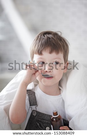 boy drinking cough syrup