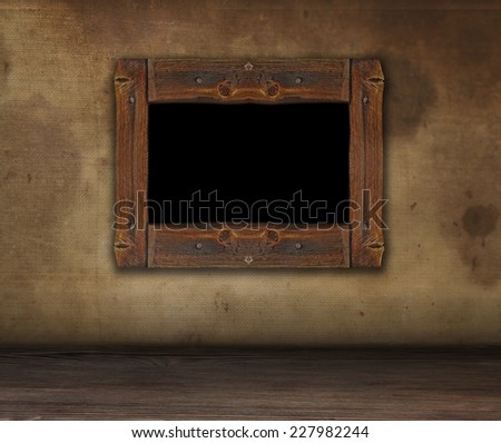 Rough wooden frame for painting grunge. Dirty wall with frame. Copy space.