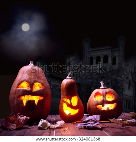 Jack o lanterns Halloween pumpkin face on sinister castle and moon background