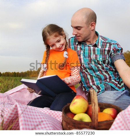 father and child read book