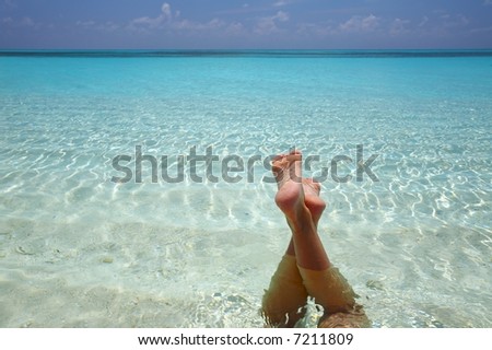 Women are relaxinhg in the  warm water of the Indian Ocean