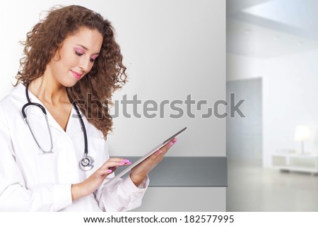 young and beautiful woman holding a portable computer