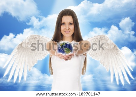 beautiful young angel woman holding Earth in hands with clouds