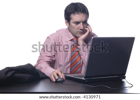 The businessman in a suit behind a table, with portable PC...