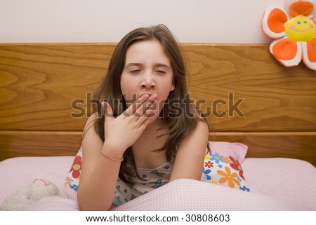 a young girl in bed very sleepy