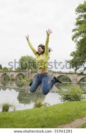 a young woman jumping in the park