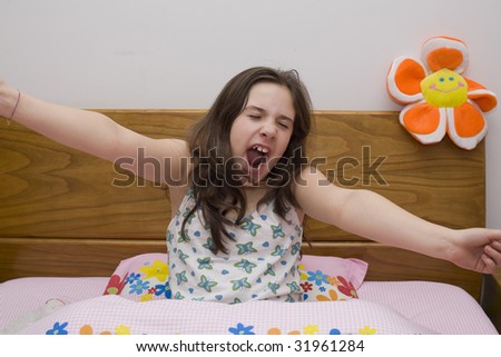 a young girl in bed very sleepy and lazzy