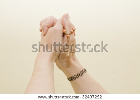 crossed hands holding a cross